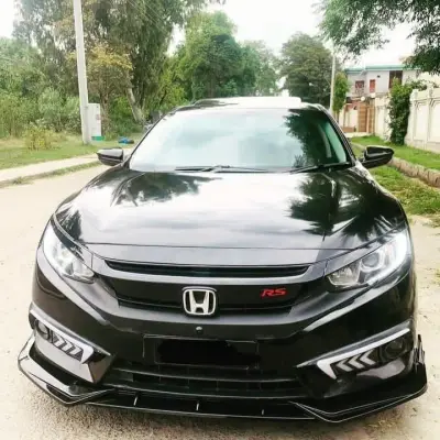 Black Toyota Corolla with custom body kit, red rims, and front splitter — premium car accessories for Toyota in Pakistan