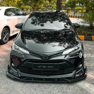 Black Toyota Corolla with custom body kit, red rims, and front splitter — premium car accessories for Toyota in Pakistan